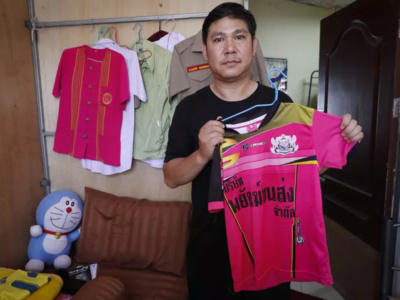 Banphot Konkum, father of Duangpetch Promthep, one of the rescued Thai boys, shows his son’s soccer jersey during an interview at their home in Mae Sai district, Chiang Rai province, northern Thailand. (AP)
