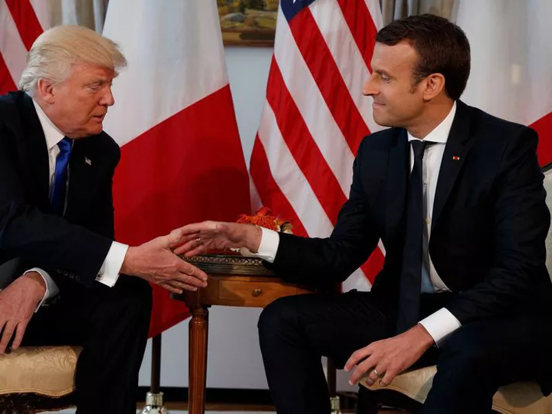 US President Donald Trump, shakes hands with French President Emmanuel
Macron. (AP)