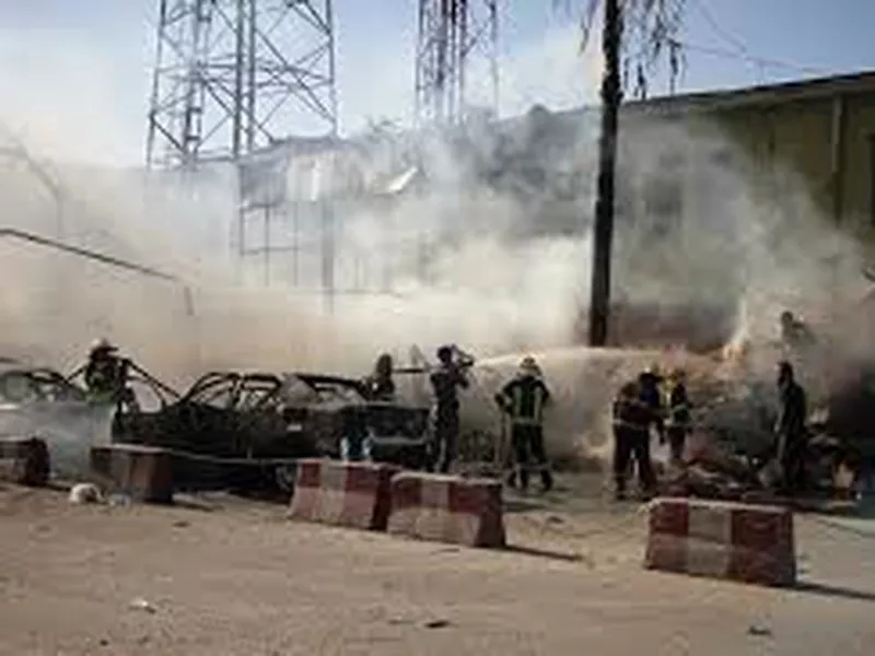 Police and fireman work at the site of a deadly suicide attack in Jalalabad.