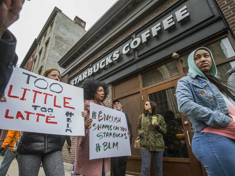Protesters gather outside of a  Starbucks in Philadelphia, Sunday, where two black men were arrested Thursday after employees called police to say the men were trespassing. The arrest prompted accusations of racism on social media.