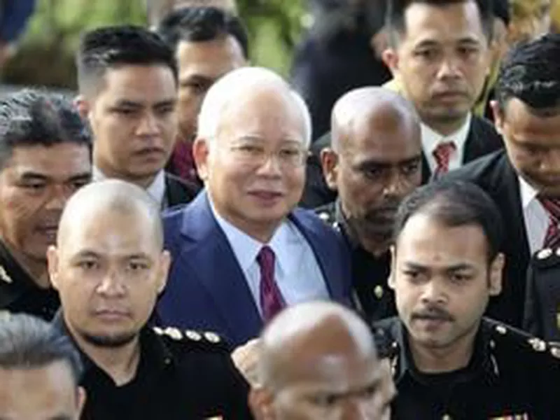 Former Malaysian Prime
Minister Najib Razak, center,
arrives at a court house
in Kuala Lumpur, Malaysia.
