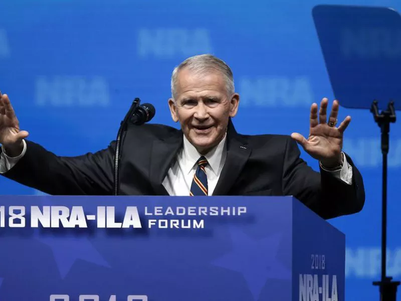 Former U.S. Marine Lt. Col. Oliver North acknowledges attendees as he
gives the Invocation at the National Rifle Association-Institute for Legislative
Action Leadership Forum in Dallas.