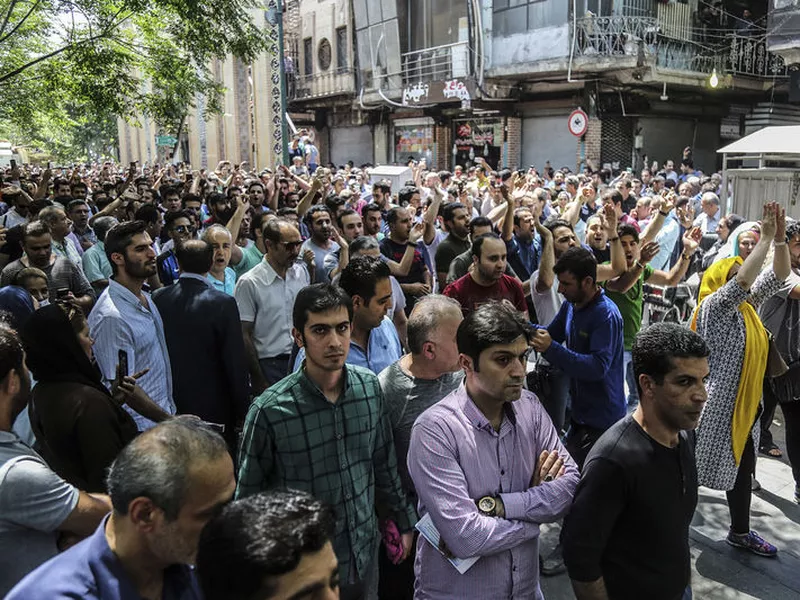 A group of protesters chant slogans at the old grand bazaar in Tehran, Iran.