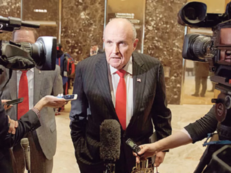 Former New York City Mayor Rudy Giuliani talks with reporters in the lobby of Trump Tower in New York. (AP)