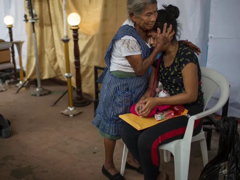 A woman embraces Francisca Nij who mourns the death of her mother Maritza Nij Ramos Davila, 40, during her wake in Alotenango, Guatemala. (AP)