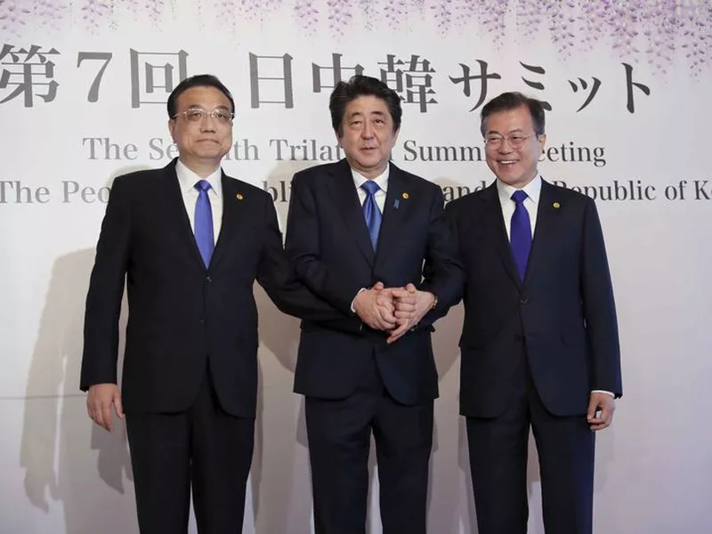 Chinese Premier Li Keqiang, left, Japanese Prime Minister Shinzo Abe, center, and South Korean President Moon Jae-in, right.
