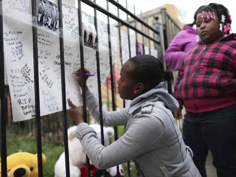 Family and friends of Endia Martin sign posters at a memorial for the
slain 14-year-old in Chicago.