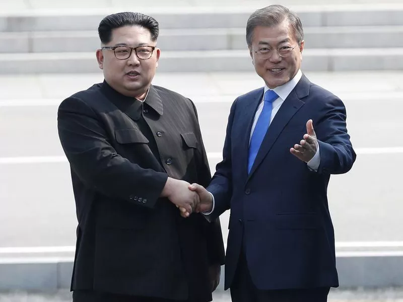 North Korean leader Kim Jong Un, left, shakes hands with South Korean President Moon Jae-in as Kim crossed the border into South Korea for their historic face-to-face talks, in Panmunjom. (AP).