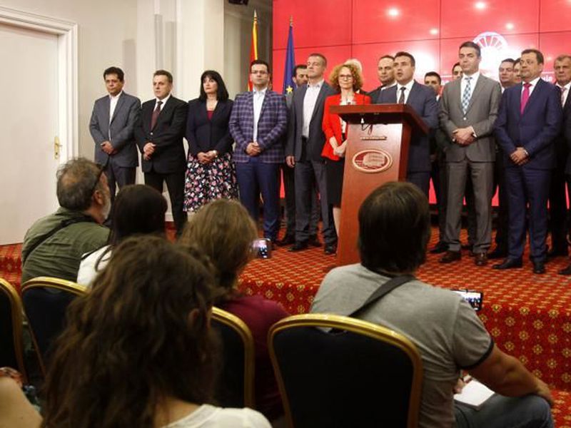 Macedonian Prime Minister Zoran Zeav, center, accompanied by the members of his cabinet, addresses the media during a news conference in the Government building in Skopje, Macedonia.