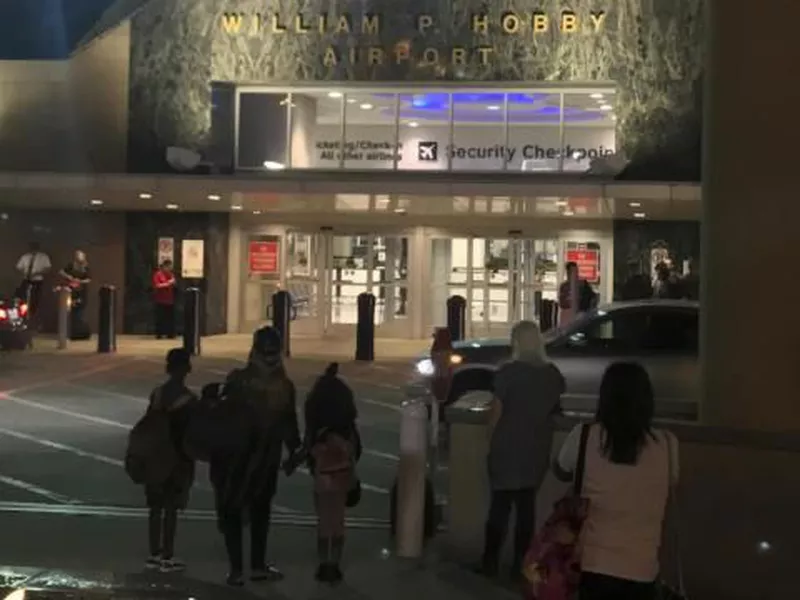 People wait outside Houston’s William P. Hobby Airport, after a toy grenade in a passenger’s bag forced the shutdown of a security checkpoint.