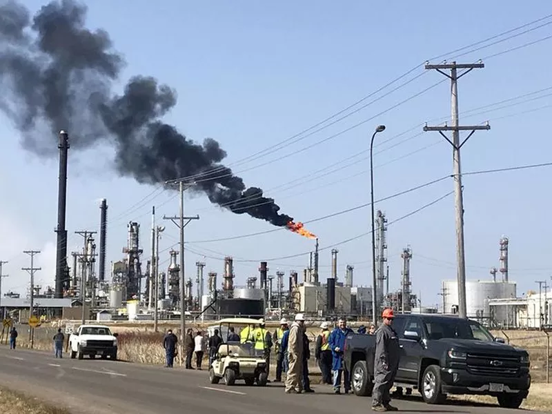 vehicles and personnel outside the Husky Energy oil refinery, after a tank containing crude oil or asphalt exploded at the large refinery in Superior, Wis. (AP)
