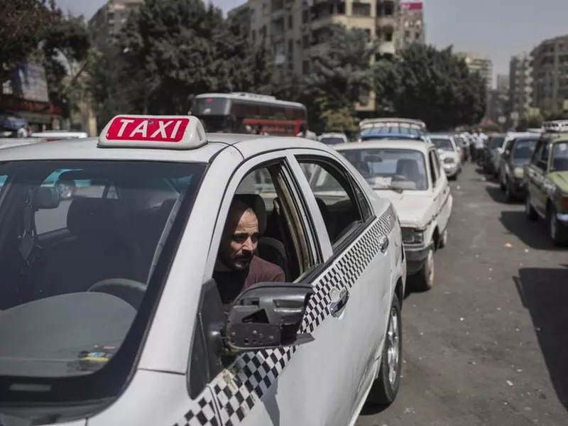 A taxi driver waits in line for fuel at a gas station in Cairo’s. (AP)