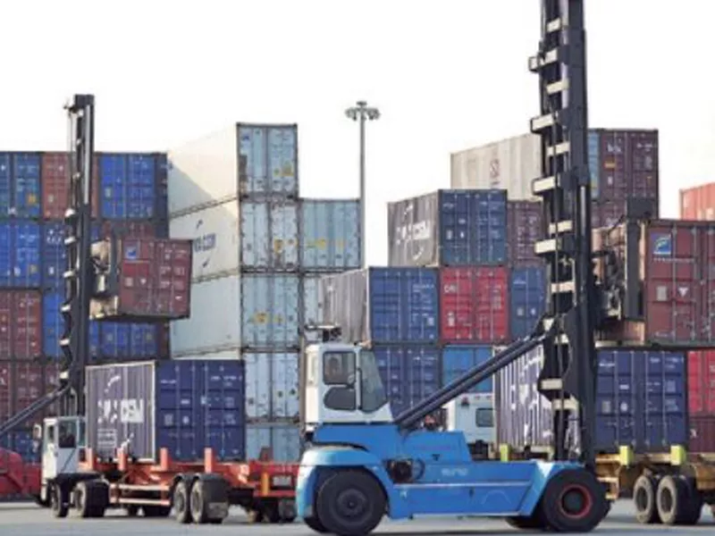 Workers move containers at a port in Qingdao in eastern China’s Shandong province. (AP)